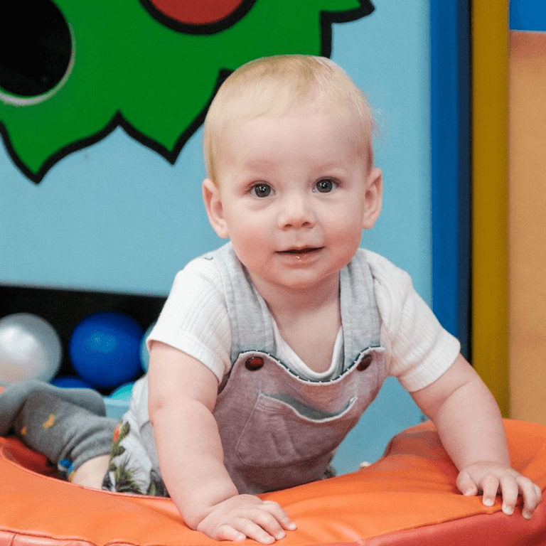 A baby crawling in the soft play area at Jack in the Box Club soft play for babies, exploring and enjoying a safe and colourful environment.