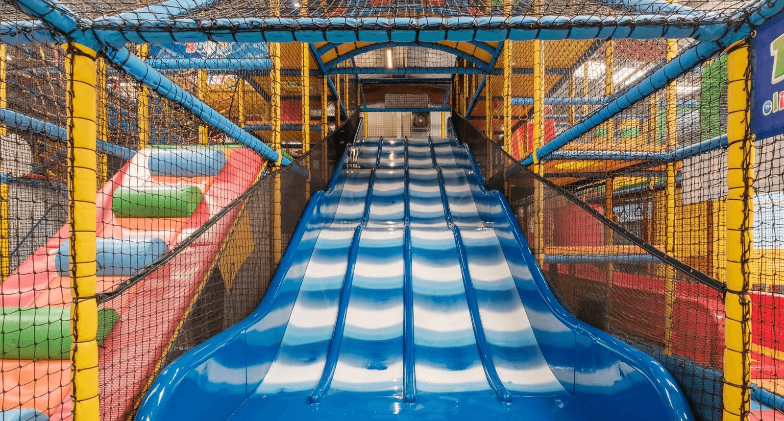 A vibrant soft play slide at Jack in the Box Club in Hull, offering children a safe, fun sliding experience in a colourful, interactive play area.